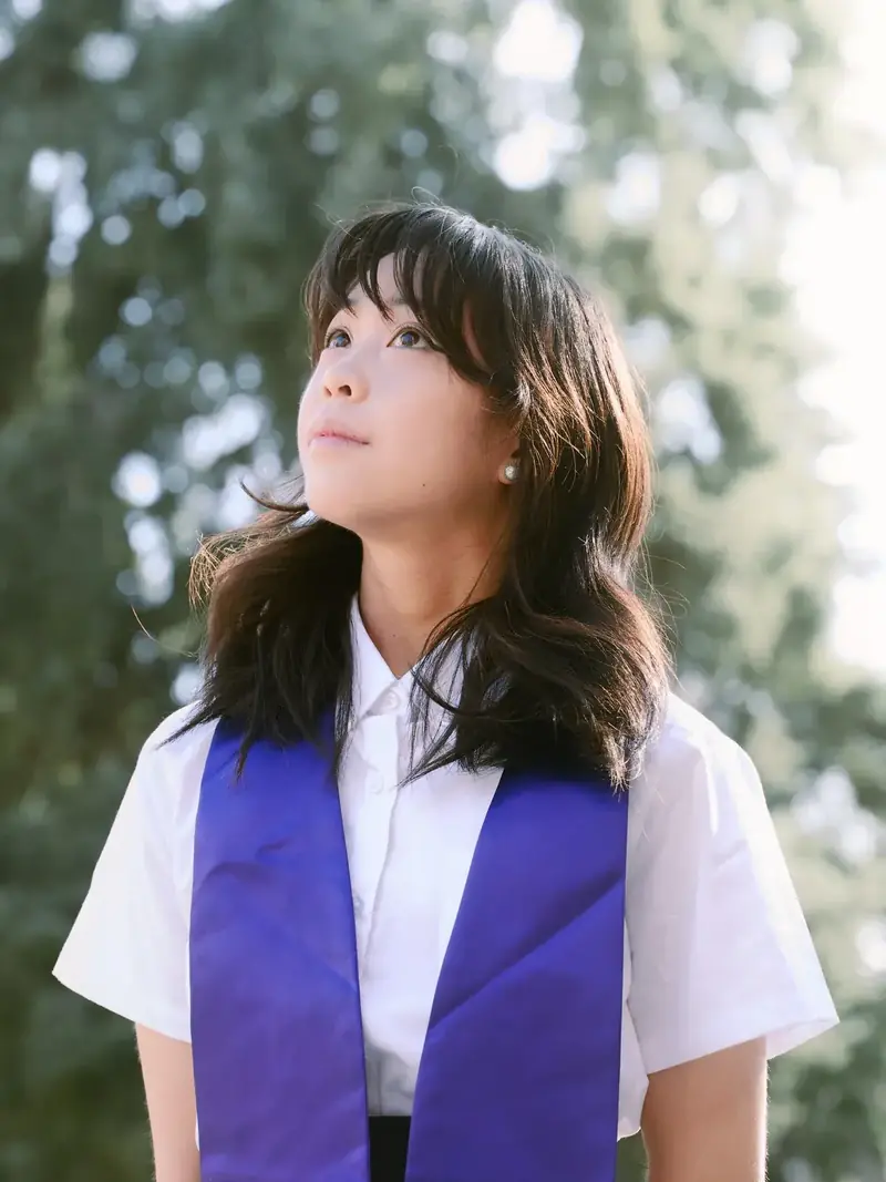 University of Washington senior portrait among spring cherry blossoms in Seattle