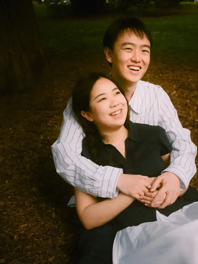 Candid golden hour engagement photography in Seattle with warm sun flares